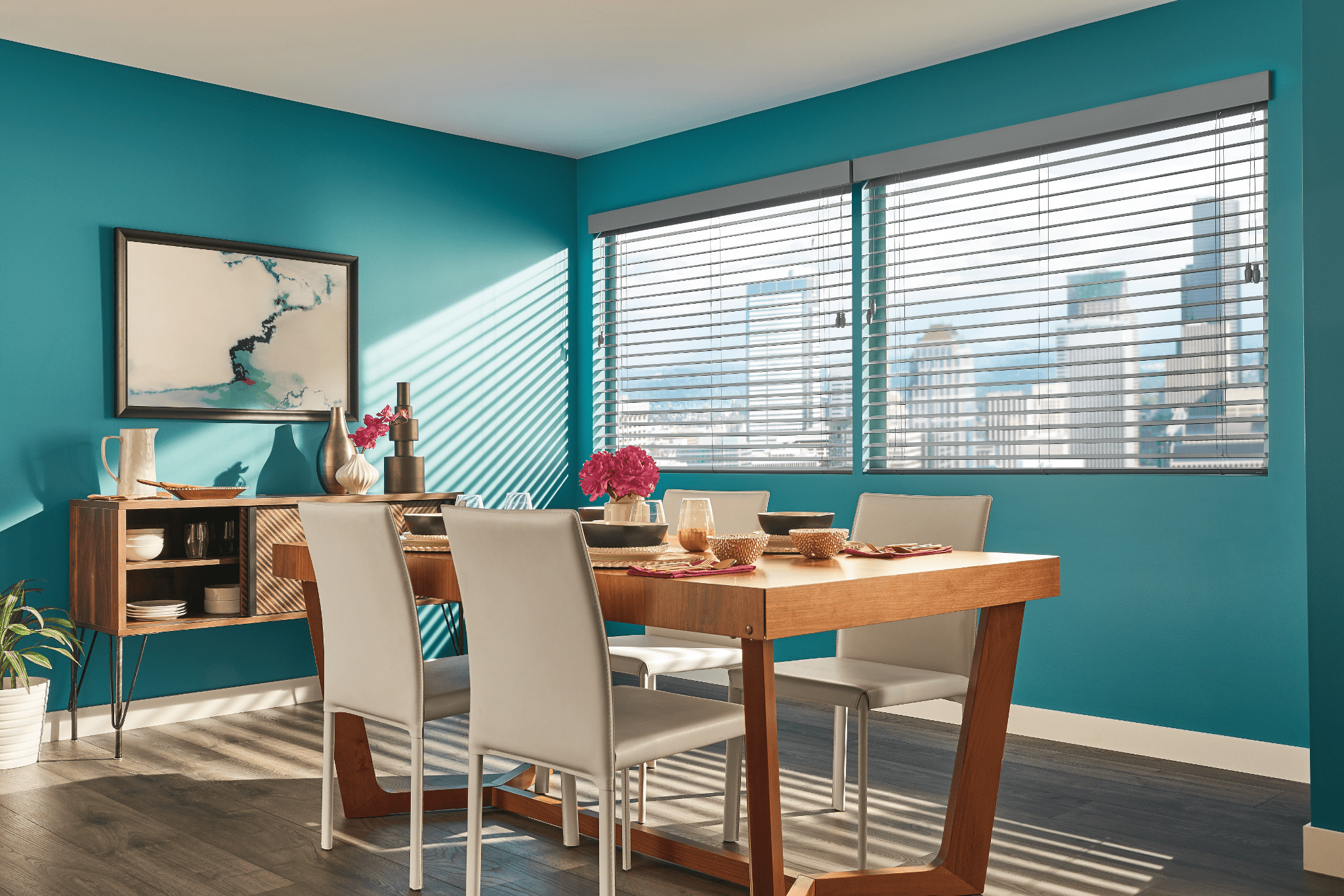 Faux wood blinds covering large windows in a dining room