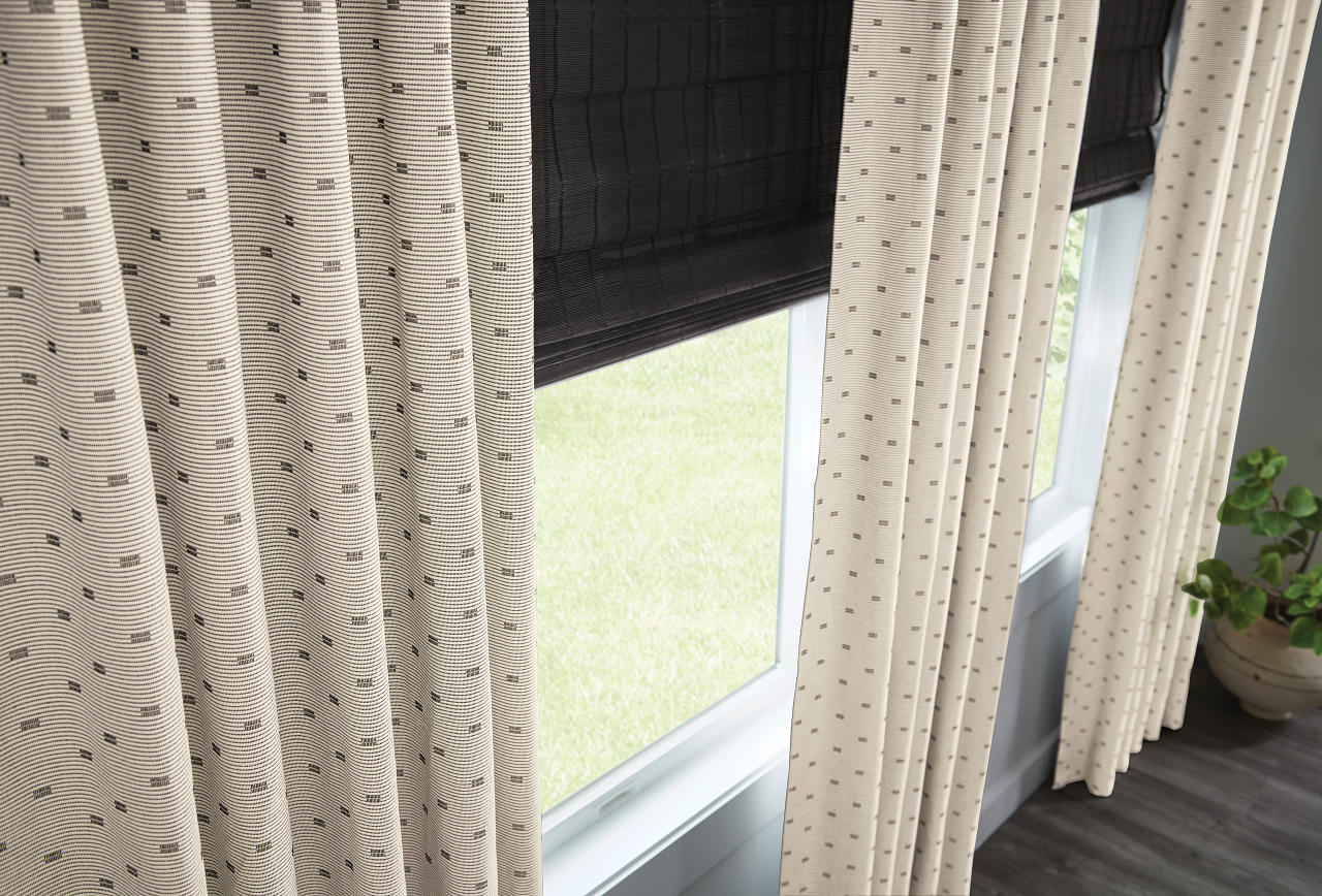 Custom drapery with natural shades in a styled living space